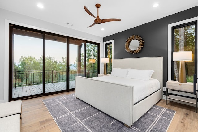 bedroom featuring ceiling fan, wood-type flooring, and access to exterior