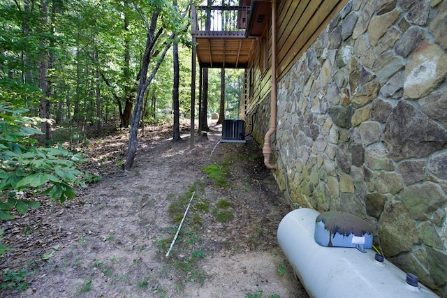 view of yard with cooling unit and a deck