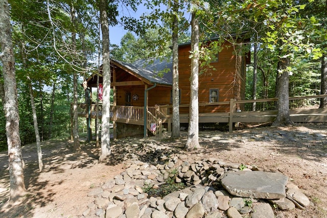 view of side of home featuring a wooden deck