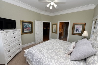 carpeted bedroom with crown molding and ceiling fan