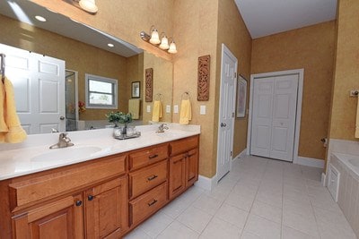 bathroom with vanity, tile patterned flooring, and separate shower and tub