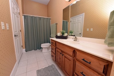 bathroom with vanity, tile patterned flooring, and toilet