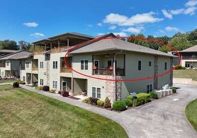 view of property exterior with a balcony and a yard