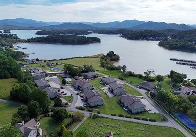 birds eye view of property featuring a water and mountain view