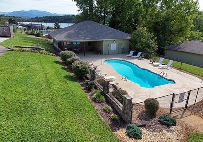 view of swimming pool featuring a water and mountain view, a lawn, and a patio