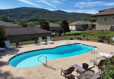 view of swimming pool featuring a mountain view and a patio area