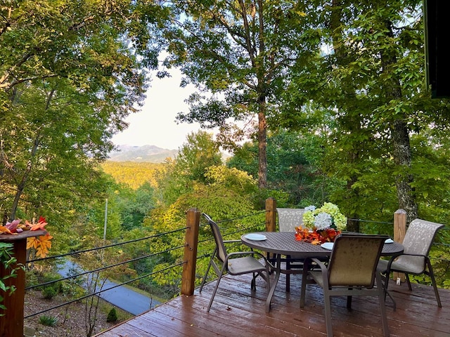 149 Poormans Trl, Murphy, NC 28906 - deck featuring outdoor dining area, a view of trees, and a mountain view