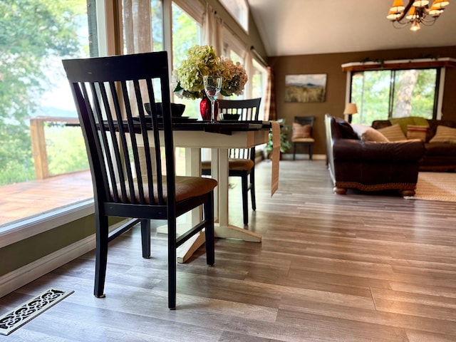 149 Poormans Trl, Murphy, NC 28906 - dining area featuring a chandelier, healthy amount of natural light, wood finished floors, and lofted ceiling