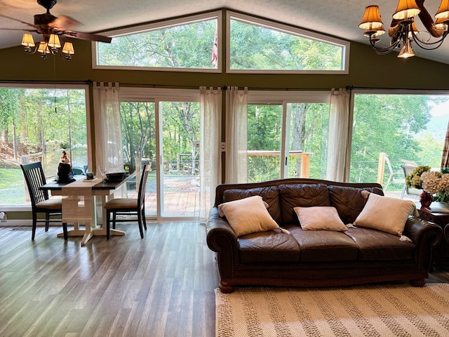 149 Poormans Trl, Murphy, NC 28906 - living area with vaulted ceiling, ceiling fan, wood finished floors, and a chandelier