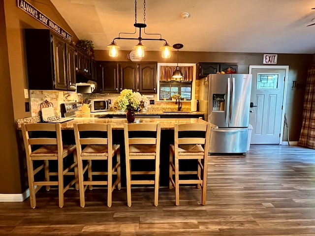 149 Poormans Trl, Murphy, NC 28906 - kitchen with stainless steel appliances, dark wood-style floors, tasteful backsplash, and under cabinet range hood