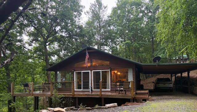 149 Poormans Trl, Murphy, NC 28906 - back of property featuring an attached carport, a wooden deck, and gravel driveway