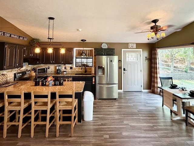 149 Poormans Trl, Murphy, NC 28906 - kitchen featuring stainless steel appliances, vaulted ceiling, decorative backsplash, wood finished floors, and dark brown cabinets