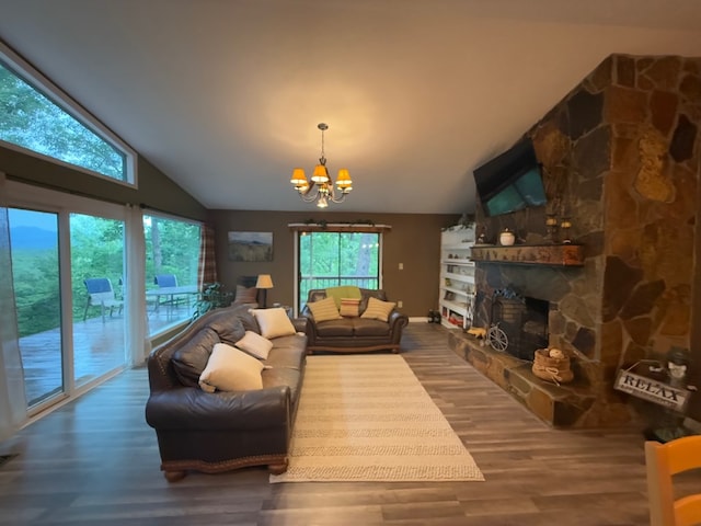 149 Poormans Trl, Murphy, NC 28906 - living room with a chandelier, lofted ceiling, plenty of natural light, wood finished floors, and a fireplace