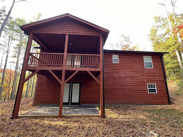 back of house featuring a balcony