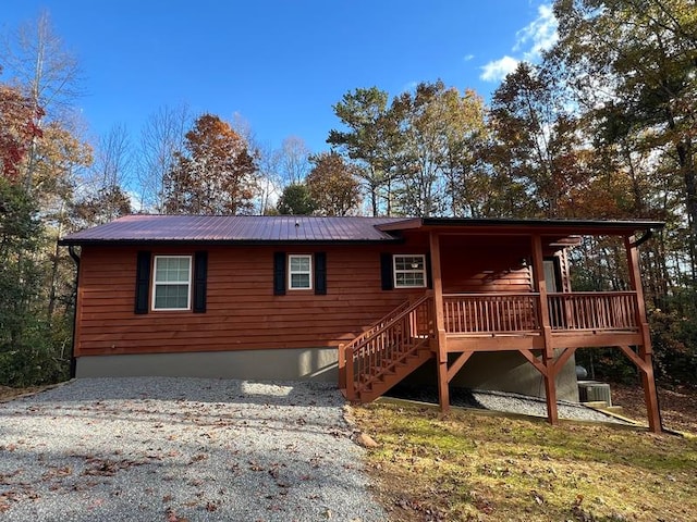 back of house with a deck and central AC unit