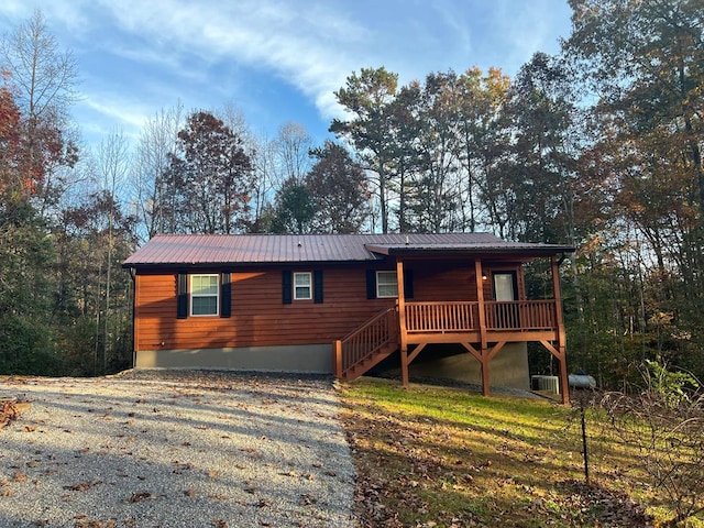 view of front of house with a deck and cooling unit