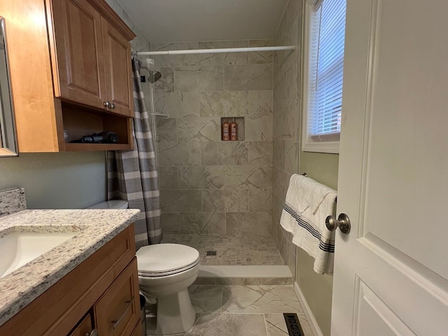 bathroom with walk in shower, vanity, and toilet