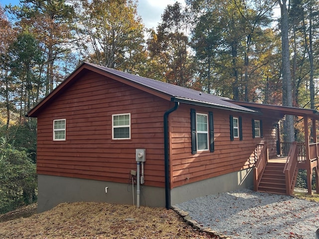 view of property exterior with a wooden deck