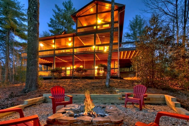 back of house featuring an outdoor fire pit