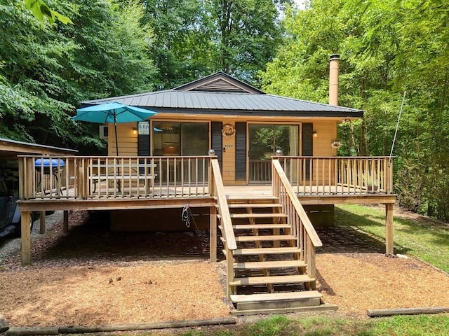 rear view of property with a wooden deck