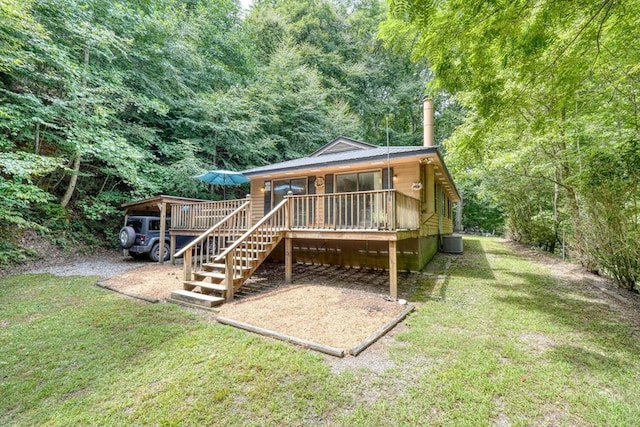 rear view of property with a porch, a yard, and central AC unit