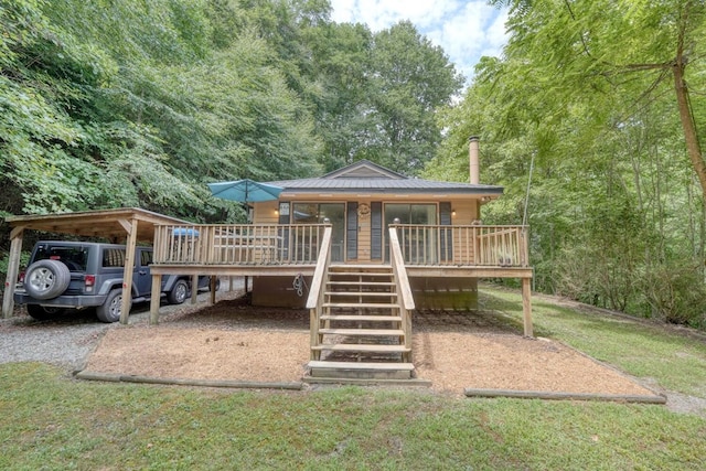 rear view of property featuring a yard and covered porch