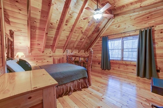 bedroom featuring wood walls, wooden ceiling, vaulted ceiling with beams, and light wood-style floors