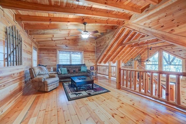 living room featuring lofted ceiling with beams, wooden ceiling, wood-type flooring, and a ceiling fan