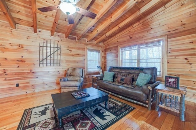 living room with wood walls, wooden ceiling, vaulted ceiling with beams, and hardwood / wood-style flooring