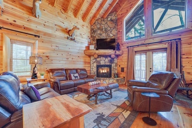 living room featuring wood-type flooring, high vaulted ceiling, a wealth of natural light, and wooden ceiling