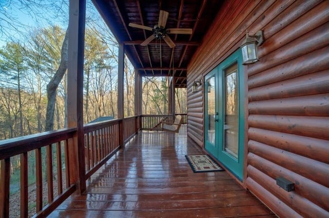 wooden deck with ceiling fan and french doors