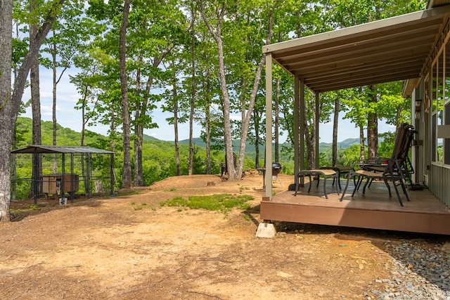 view of yard with a deck with mountain view