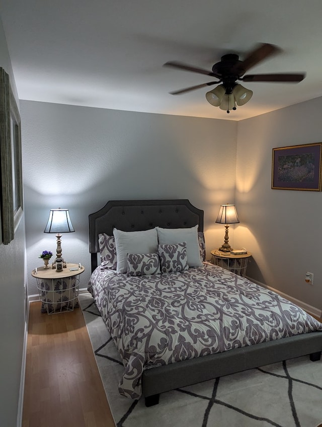 bedroom featuring ceiling fan and wood-type flooring