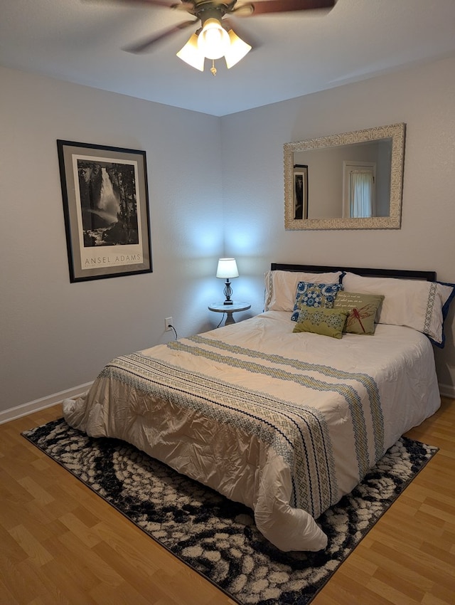 bedroom with hardwood / wood-style flooring and ceiling fan