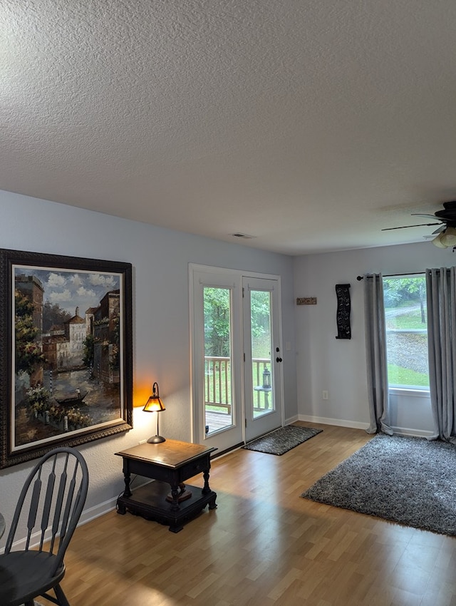 interior space featuring a textured ceiling and light wood-type flooring