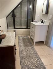 bathroom with tile patterned floors, bath / shower combo with glass door, and vanity