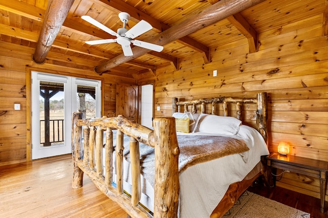 bedroom with beamed ceiling, wooden ceiling, and wood finished floors