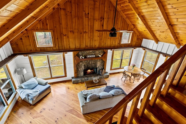 living room featuring wooden walls, a fireplace, and hardwood / wood-style floors