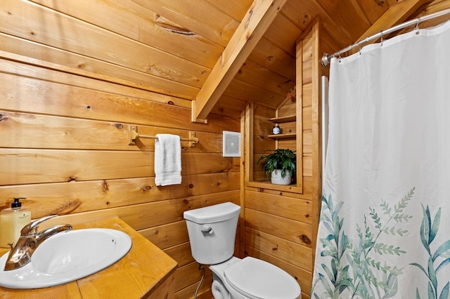 bathroom with toilet, wood ceiling, wood walls, and a sink