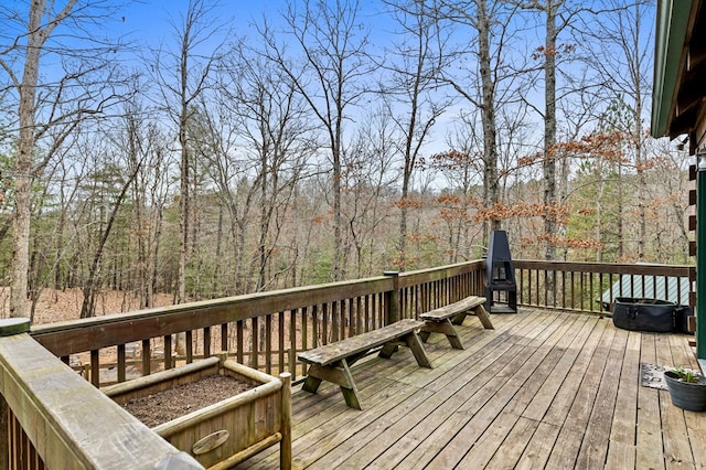 wooden terrace with a view of trees