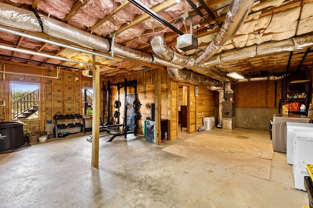 basement featuring heating unit and independent washer and dryer