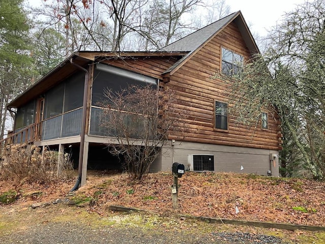 view of property exterior featuring a sunroom and central AC unit