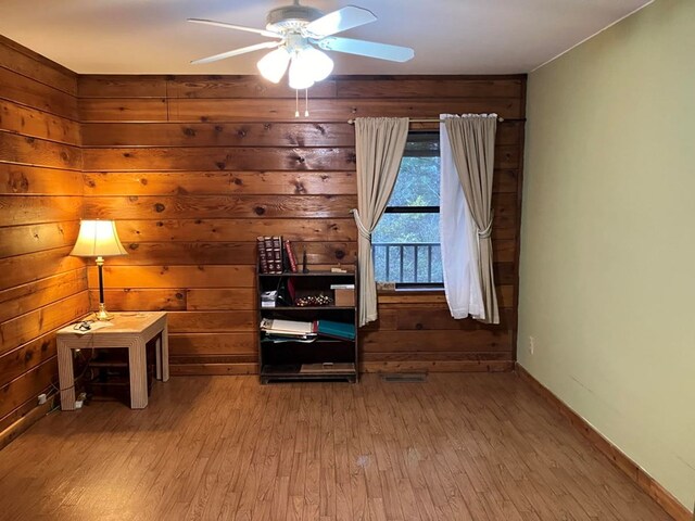 147 Holly Ridge Ln, Murphy, NC 28906 - unfurnished room featuring hardwood / wood-style flooring, ceiling fan, and wooden walls