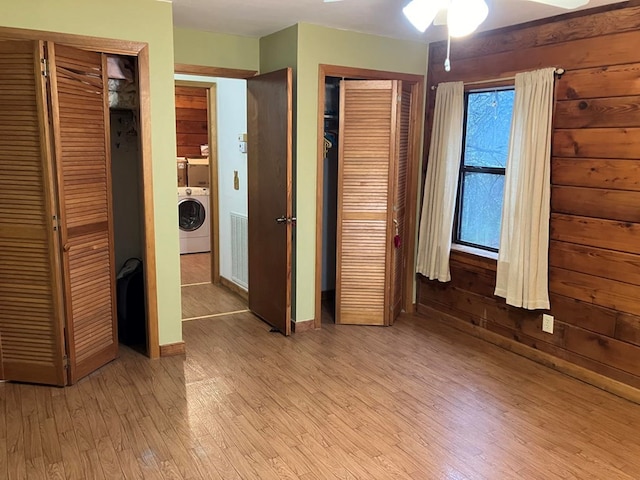 147 Holly Ridge Ln, Murphy, NC 28906 - unfurnished bedroom featuring washer / clothes dryer, multiple closets, and light wood-type flooring