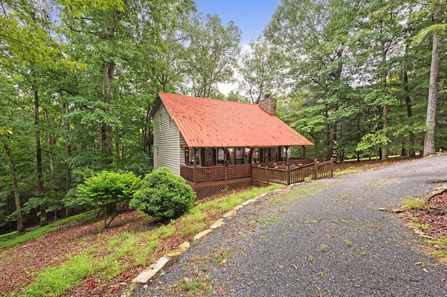 80 Stegall Mill Rdg, Ellijay, GA 30536 - view of side of home with a chimney, a metal roof, and covered porch