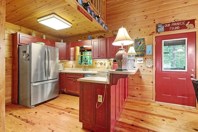80 Stegall Mill Rdg, Ellijay, GA 30536 - kitchen featuring appliances with stainless steel finishes, light wood finished floors, a peninsula, light countertops, and a breakfast bar