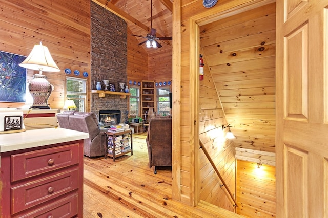 80 Stegall Mill Rdg, Ellijay, GA 30536 - kitchen featuring light wood finished floors, wooden walls, wooden ceiling, a ceiling fan, and a stone fireplace