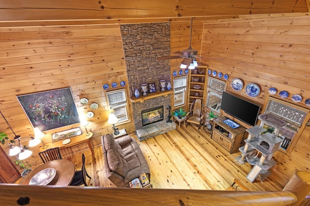 80 Stegall Mill Rdg, Ellijay, GA 30536 - living room featuring wood walls, hardwood / wood-style floors, and a stone fireplace
