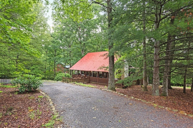 80 Stegall Mill Rdg, Ellijay, GA 30536 - view of front of home featuring covered porch, asphalt driveway, a metal roof, and a view of trees