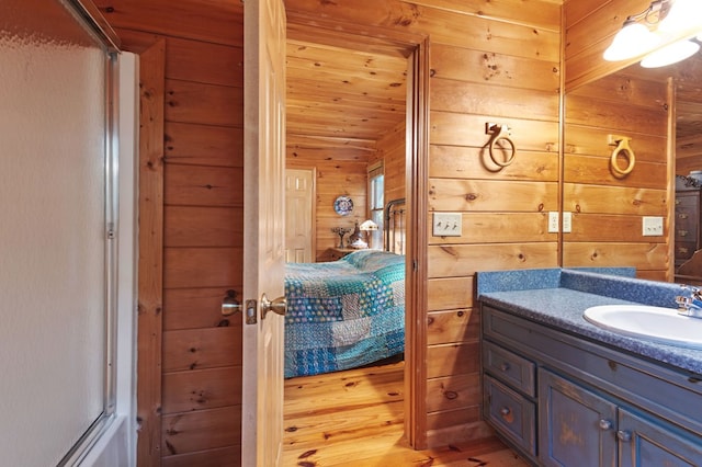 80 Stegall Mill Rdg, Ellijay, GA 30536 - bathroom featuring wooden walls, ensuite bath, vanity, and wood finished floors